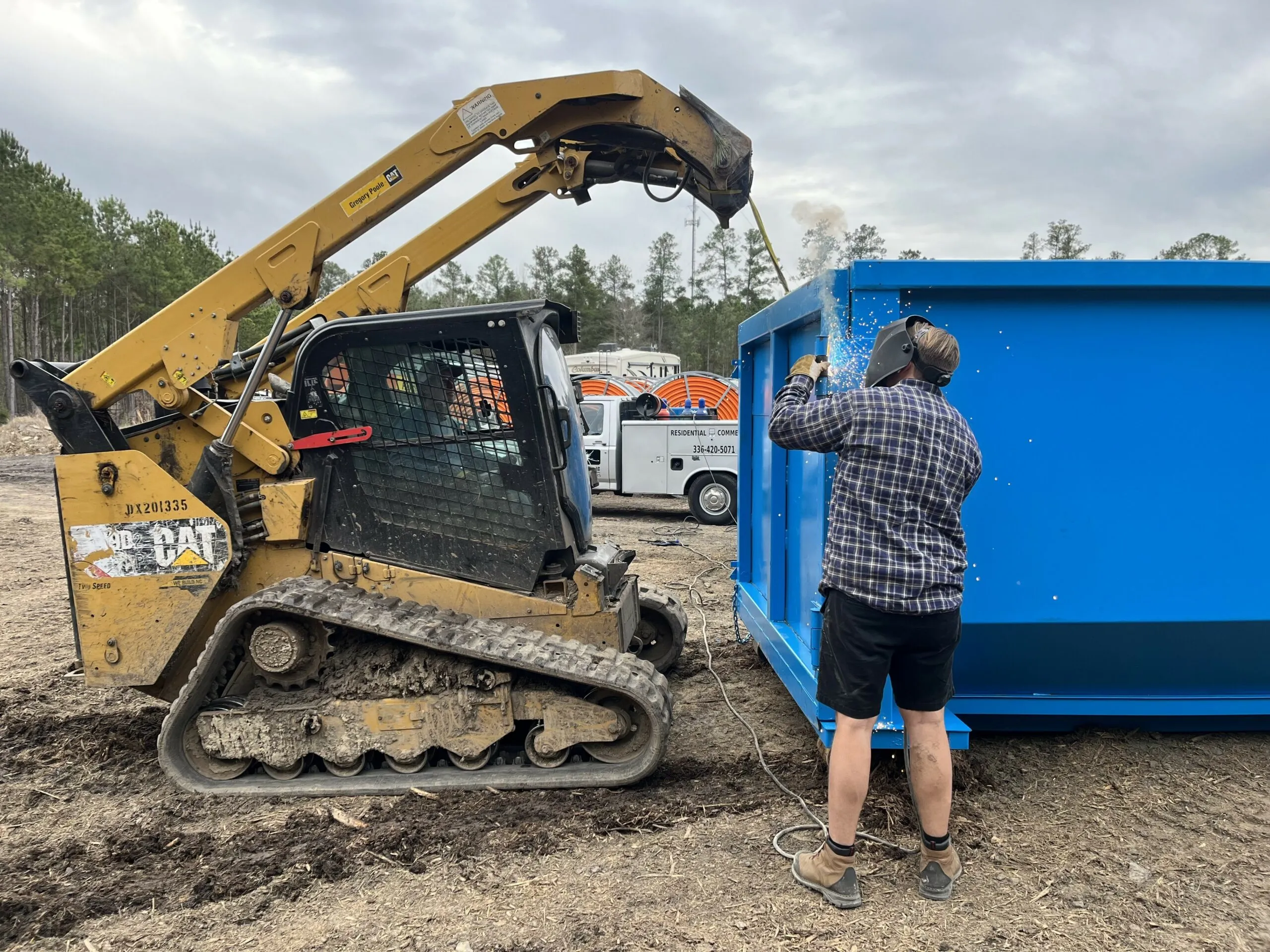 Reliable blue roll-off container being prepared